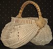 Ribbed reed basket with intricately worked gussets and
cane braiding on handle.
