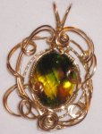Heat treated faceted citrine Packers colors pendant in gold
filled wire setting.